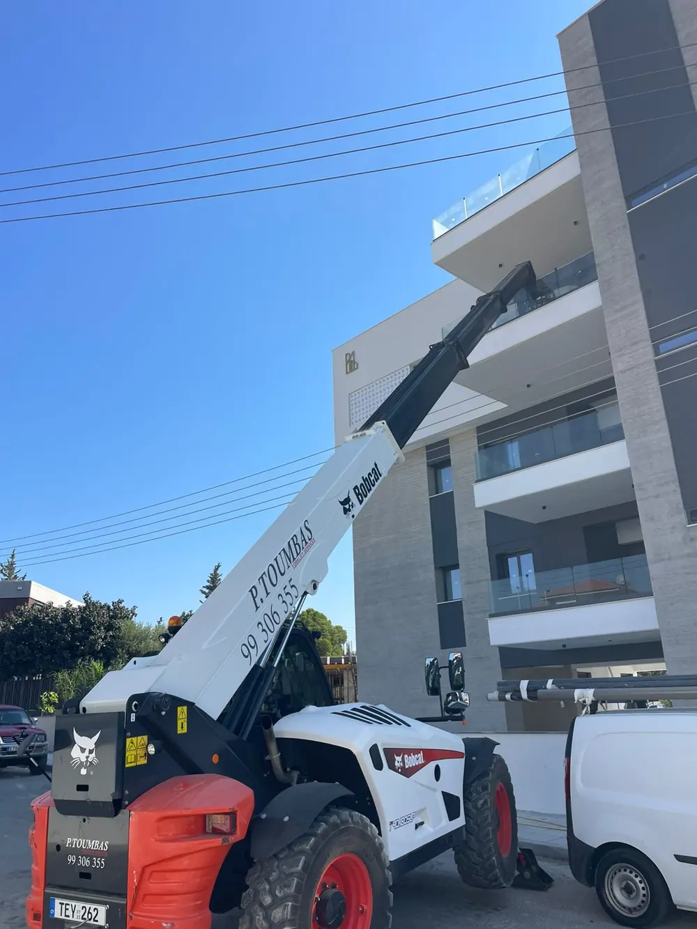 Telescopic forklift at a modern building in Limassol